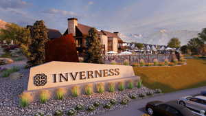 Community / neighborhood sign with a mountain view, a lawn, and a residential view