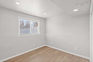 Unfurnished room with light wood-style floors and recessed lighting