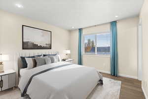 Bedroom with wood finished floors and recessed lighting
