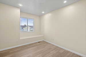 Spare room with light wood-style floors and recessed lighting