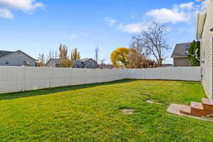 Fenced backyard with a residential view