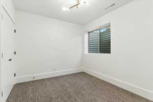 Unfurnished room with baseboards and carpet