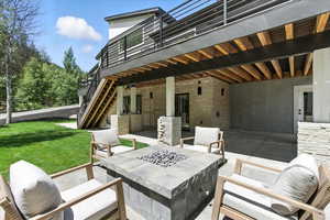 View of patio featuring stairs and an outdoor fire pit