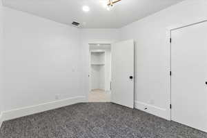 Unfurnished bedroom featuring light carpet and recessed lighting