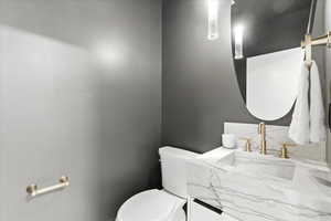 Half bathroom featuring toilet and vanity