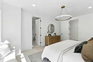 Bedroom with recessed lighting and connected bathroom