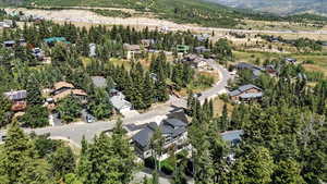 Aerial view of property and surrounding area featuring nearby suburban area