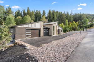 Garage with a view of trees