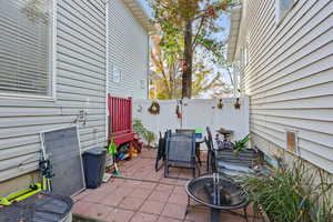 Fenced backyard with a patio, a fire pit, and a gate