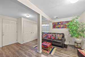 Living area with a textured ceiling and wood finished floors