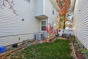 View of side of home with a cooling unit and a patio