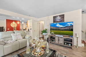Living area with wood finished floors and a textured ceiling