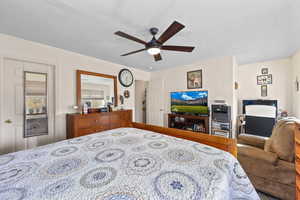 Bedroom featuring a textured ceiling and a ceiling fan