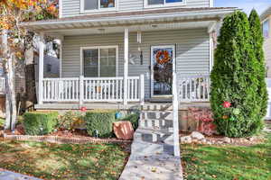 Entrance to property featuring covered porch