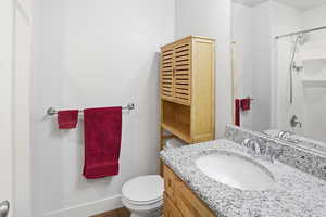 Bathroom featuring curtained shower and vanity