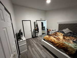 Bedroom featuring dark wood-style flooring