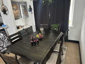 Dining room with a textured wall and light tile patterned floors