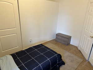 Bedroom featuring tile patterned floors and baseboards