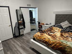 Bedroom featuring dark wood-type flooring