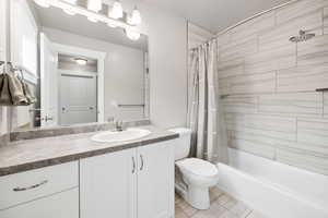 Upstairs Full Bathroom featuring shower / bathtub combination and vanity
