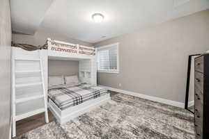 Bedroom featuring baseboards and wood finished floors
