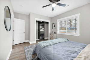 2nd Basement Bedroom featuring wood finished floors, a ceiling fan, and a closet