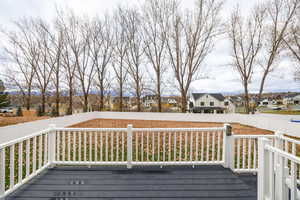 Covered Deck Wooden terrace featuring a residential view and a fenced backyard