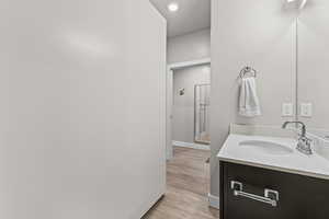 Bathroom with vanity and light wood-type flooring
