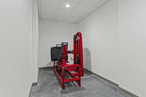 Misc room featuring a drop ceiling and baseboards