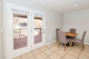 Dining room featuring light tile patterned flooring, a textured ceiling, and recessed lighting