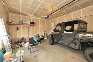 Garage featuring a garage door opener