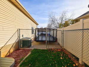 Fenced backyard with a gate and a patio