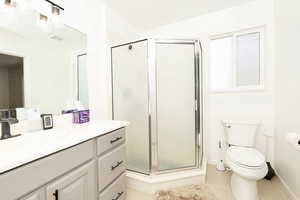 Full bathroom with a stall shower and vanity