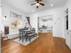 Dining space with ornamental molding, light wood-style floors, ceiling fan, and recessed lighting