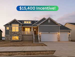 Craftsman-style home featuring stone siding, board and batten siding, a porch, and driveway