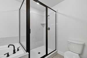 Full bathroom with a garden tub and a marble finish shower