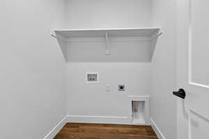 Washroom with dark wood finished floors, hookup for an electric dryer, and washer hookup