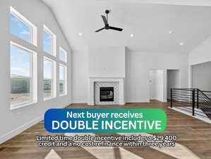 Unfurnished living room with a tile fireplace, dark wood-type flooring, recessed lighting, a ceiling fan, and high vaulted ceiling