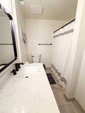 Bathroom with a shower with shower curtain, vanity, and light tile patterned floors