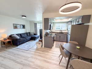 Living room with a textured ceiling and light wood finished floors