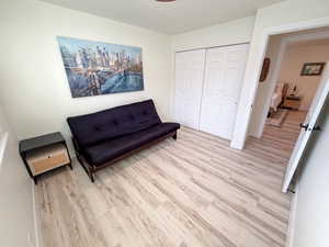 Sitting room with wood finished floors and baseboards