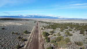 View of rural area with a mountain backdrop and a desert landscape