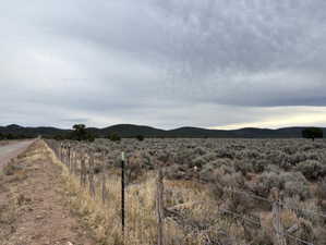 View of mountain backdrop featuring rural landscape