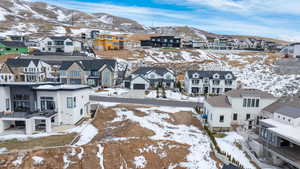 Snowy aerial view with a residential view and a mountain view