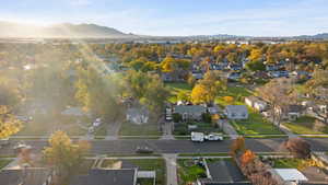 Aerial overview of property's location with mountains and nearby suburban area