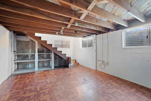 Unfinished below grade area featuring stairs