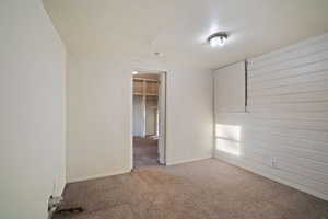 Unfurnished bedroom with carpet floors and a spacious closet