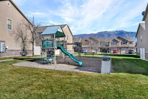 Community playground featuring a mountain view and a residential view