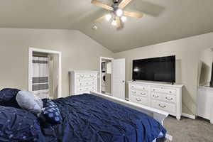 Carpeted bedroom with lofted ceiling, ceiling fan, and washer / clothes dryer