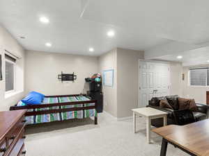 Bedroom featuring light colored carpet, recessed lighting, and a closet